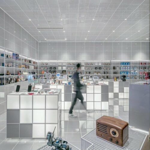 man walking beside white cube decoration