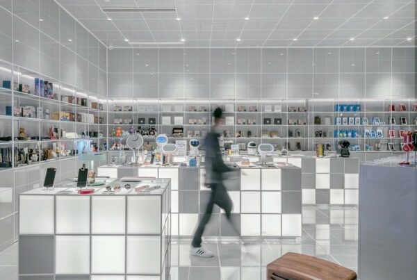 man walking beside white cube decoration